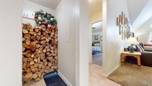 a living room with a stack of fire wood at Aspen Creek #311 condo in Mammoth Lakes