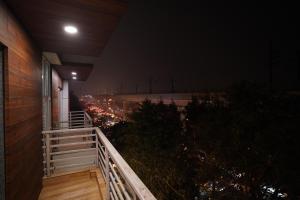 a balcony of a building at night with lights at Hotel Lyf Corporate Suites - Peera Garhi in New Delhi