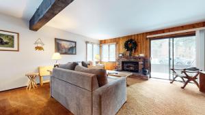 a living room with a couch and a fireplace at Wild Flower 37 Apartment in Mammoth Lakes