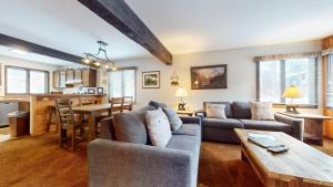 a living room with a couch and a table at Wild Flower 37 Apartment in Mammoth Lakes