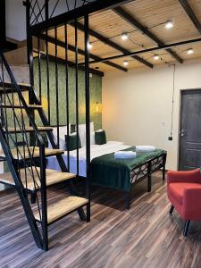 a room with a bunk bed and a staircase at Berkri Gastro Yard & Guest House in Yenokavan