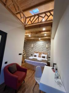 a bedroom with a bed and a table and a chair at Berkri Gastro Yard & Guest House in Yenokavan