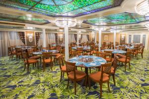 a dining room with tables and chairs and a colorful ceiling at M/S Nephtis Nile Cruise in Luxor