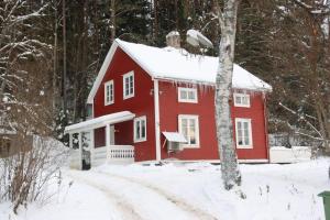 a red barn in the snow in the woods at Amnerud 5 in Amnerud