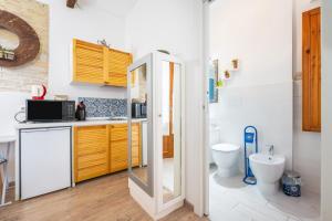a bathroom with a sink and a toilet in it at Alla Marina Monolocale in Cagliari +11 photos