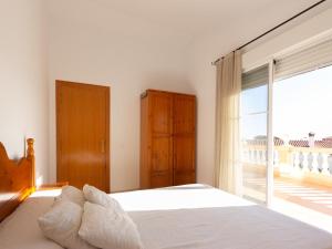 a bedroom with a bed and a large window at INNOUTHOME CASA CON PISCINA Av AMETLLA DE MAR in L'Ametlla de Mar +44 photos