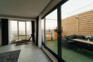 a living room with a couch and a table at Eco Penthouse&rooftop terrace. in Chişinău