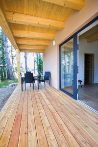 a wooden deck with a table and chairs on it at kemp Pohoda in Roudná