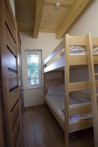 a bedroom with two bunk beds and a window at kemp Pohoda in Roudná