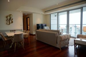 a living room with a couch and a table at Opulent Comfort in Colombo