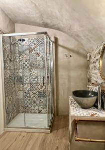 a glass shower in a bathroom with a sink at La Finestra di Dante in Mulazzo +16 photos