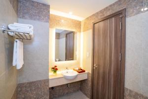 a bathroom with a sink and a mirror at Navy Hotel Cam Ranh in Cam Ranh