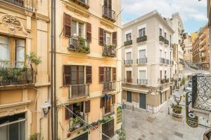 an apartment building with balconies on a city street at Alla Marina Monolocale Deluxe in Cagliari
