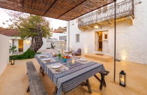 a table with a blue and white tablecloth on a patio at The Village House in Stavros