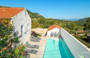 a villa with a swimming pool and a house at The Village House in Stavros