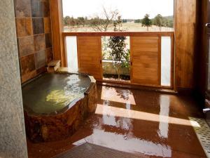 a bath tub in a room with a window at Wellness Forest Nasu in Nasu