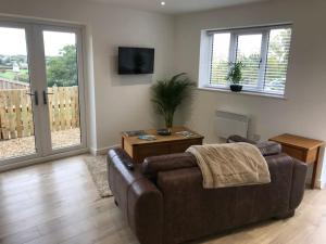 a living room with a couch and a table at Springwood farm in Kirkhamgate