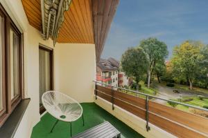 a balcony with a white chair and a window at Juri/4 Bad Dürrheim in Bad Dürrheim