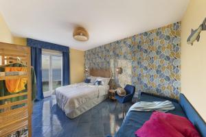 a bedroom with a bed and a couch in it at Hotel Villa Lubrense Sorrento in Massa Lubrense