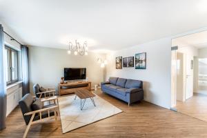 a living room with a couch and a tv at Juri/4 Bad Dürrheim in Bad Dürrheim