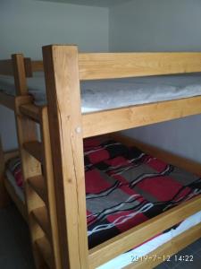 a wooden bunk bed with a blanket on it at Apartmán u Zdeňků in Modrava