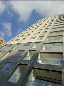 a tall white building with windows on the side of it at 1bedroom Exquisite City Apartment in Kilimani by The Manna Stays in Nairobi