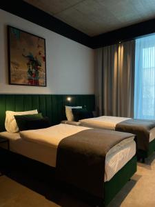 Postel nebo postele na pokoji v ubytování Fabryka Wełny Hotel & Spa
