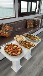 a table with several different types of food on it at Edan Storm Yacht in Hurghada