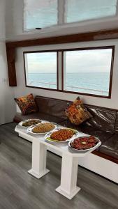 a white table with several plates of food on it at Edan Storm Yacht in Hurghada