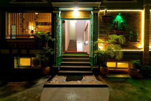 a hallway with stairs and potted plants in a building at PRIMES RESIDENCY in Kālapettai