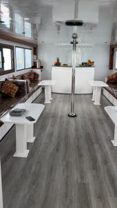 a large room with white tables and white counters at Edan Storm Yacht in Hurghada
