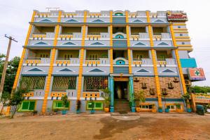 a large building with blue and yellow at PRIMES RESIDENCY in Kālapettai