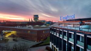 a view of a city at sunset with a building at Hunguest Szeged - ex Forrás in Szeged