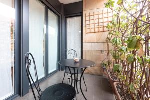 a small table and chairs on a balcony at Bicocca Terrace Two Bedroom Apartment -Top Collection in Milan