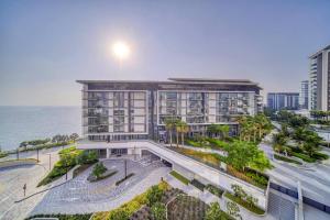 an aerial view of a building next to the ocean at Livbnb - Elegant 3BR+Maid, Sea View in Bluewaters in Dubai