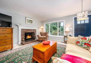 a living room with a couch and a fireplace at Cozy Cape Classic-Central AC&Near Bay Beaches in Barnstable