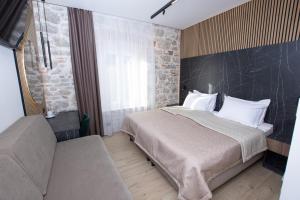 a bedroom with a large bed and a couch at A Heritage Split in Split