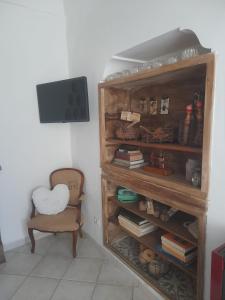 a room with a book shelf and a chair at Casa Colette in Anacapri