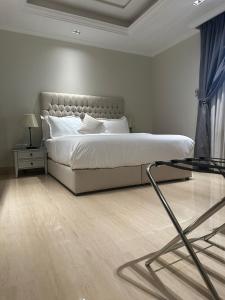 a bedroom with a bed and a glass table at GAZLA in Riyadh
