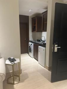 a kitchen with a washer and dryer and a table at GAZLA in Riyadh