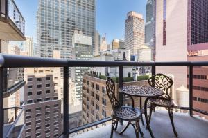 two chairs and a table on a balcony with a city skyline at Theater District Studio w Indoor pool NYC-142 in New York