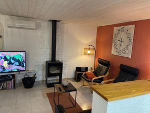 a living room with a living room with a fireplace at Mas Joviel villa Uzes in Arpaillargues-et-Aureillac