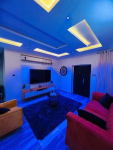 a living room with blue lights on the ceiling at Owtee’s Apartments in Port Harcourt