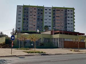a large apartment building in front of a building at DMN City Merensky Apartment in Windhoek