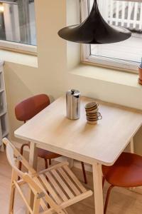 a table and chairs with a lamp and a cup on it at Fresh studio apartment, a short walk from Bryggen in Bergen