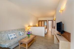 a living room with a couch and a tv at Labranda Mares Marmaris Hotel in Marmaris