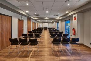 a room with rows of chairs in a room at City Express by Marriott Mexicali in Mexicali