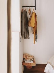 a room with a closet with clothes hanging on a wall at La Posada de Trafalgar in Los Caños de Meca