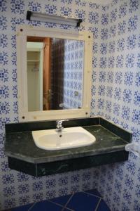 a bathroom with a sink and a mirror at Dahab Divers in Dahab