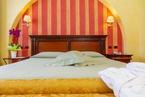 a bed with two pillows on it in a room at Hotel Arbatasar in Àrbatax